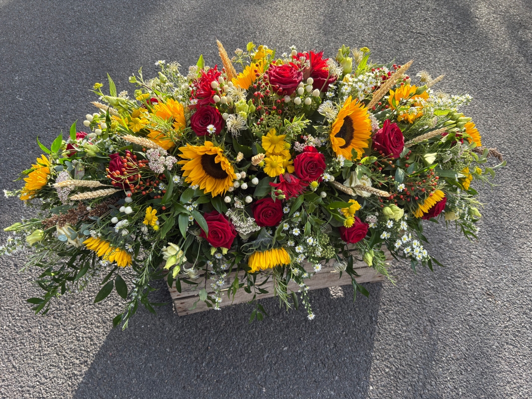 Rose and sunflower funeral spray