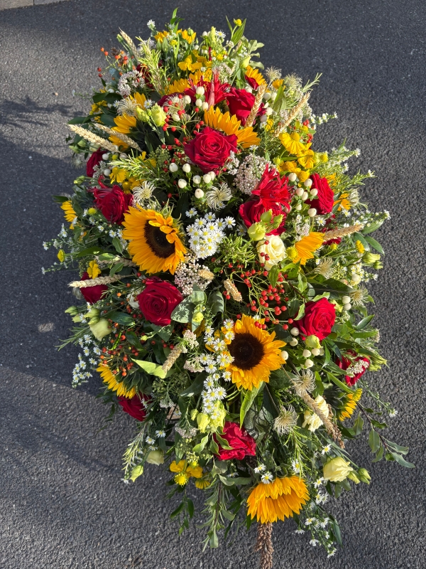 Rose and sunflower funeral spray