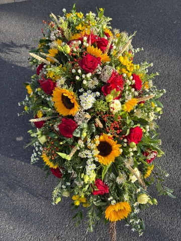 Rose and sunflower funeral spray
